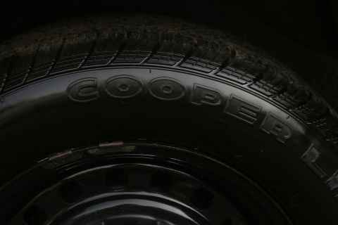 1989 Ford Crown Victoria LTD - Close-up of a Cooper tire mounted on a black steel wheel.