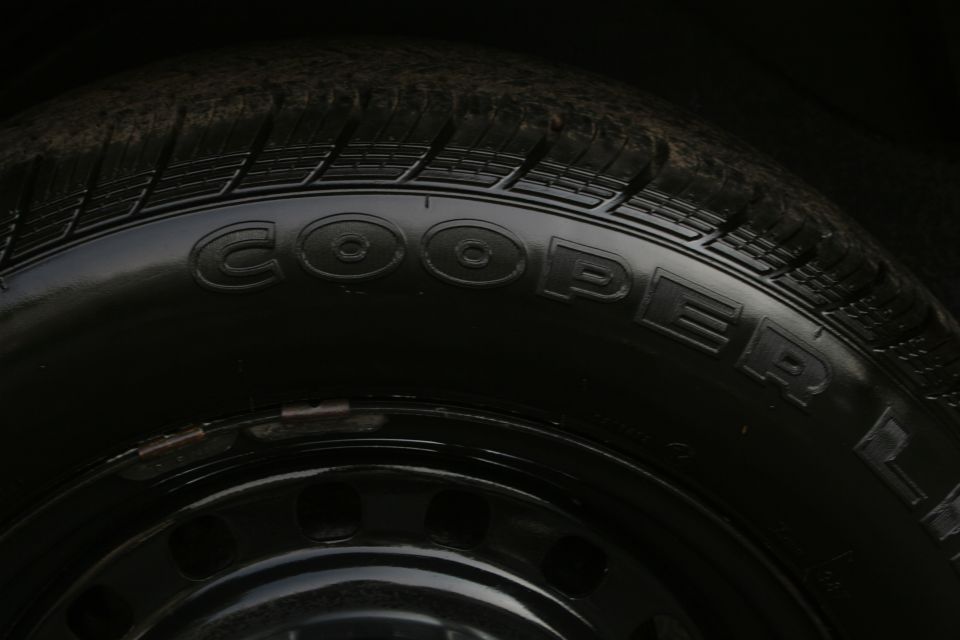 Cooper tire on a black steel wheel