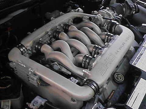 1993 Ford Taurus - Close-up of a V8 engine's intake manifold, labeled 'SHO 24 VALVE'.