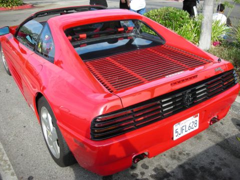 1998 Ford Crown Victoria - Rear three-quarter view of a red Ferrari 348 showing its slatted engine cover and California plate 5JFL628.