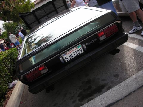 1998 Ford Crown Victoria - Rear view of a dark Lamborghini coupe with louvered rear glass and California plate 5JNJ289 in a parking lot.