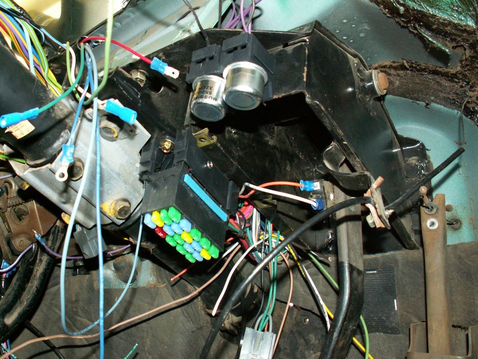 The 'Its A Snap' fuse block mounted on flat metal beside steering column....srcrewed thru the base of fuse block....21 circuits (3 more than Painless) will cover everything  ....now and for future.