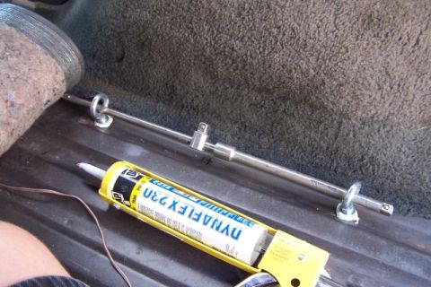 1990 Ford Bronco - Installing tie-down anchors and using sealant in the cargo area of a vehicle.