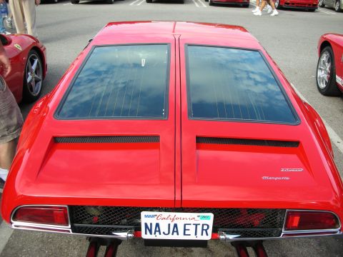 1998 Ford Crown Victoria - Rear view of a red De Tomaso Mangusta showing its twin tinted rear hatches and California plate NAJA ETR.