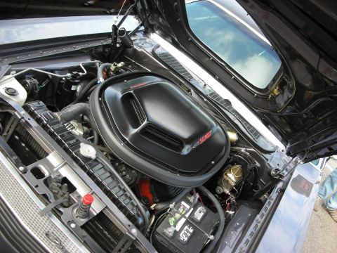 1998 Ford Crown Victoria - Engine bay featuring a black shaker-style hood scoop, chrome strut brace and a red coolant cap.