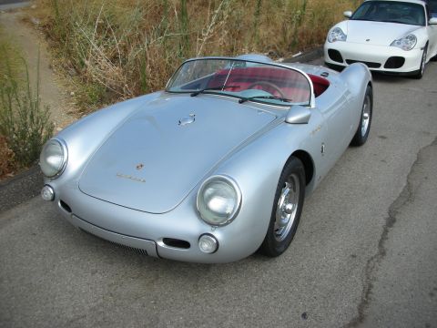 1998 Ford Crown Victoria - silver Porsche 550 Spyder-style roadster with a red interior parked on a roadside next to a white Porsche coupe.