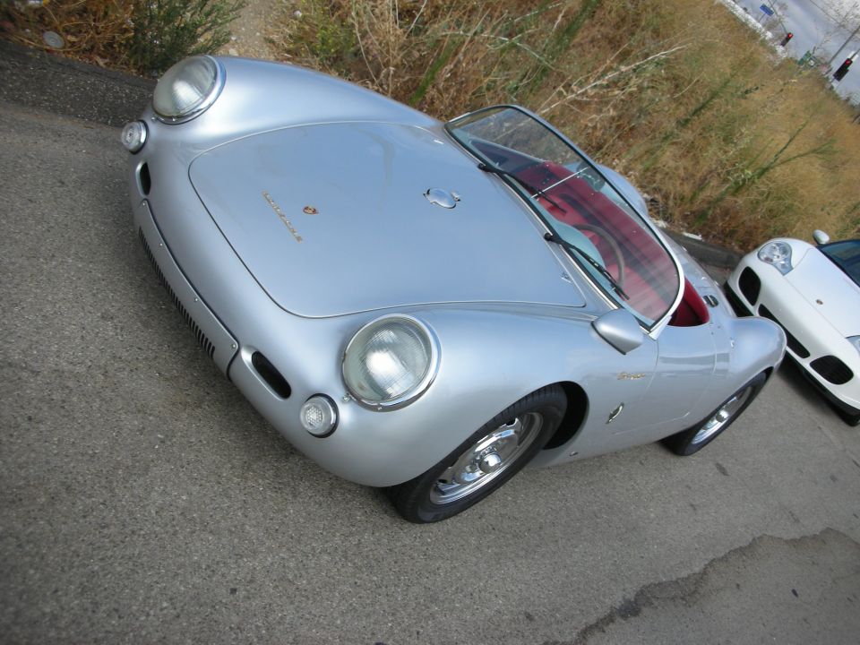 Silver Porsche 550-style coupe with low roofline parked outdoors