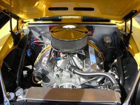 1998 Ford Crown Victoria - polished V8 with a chrome air cleaner and stainless headers fills the engine bay of a yellow custom car.