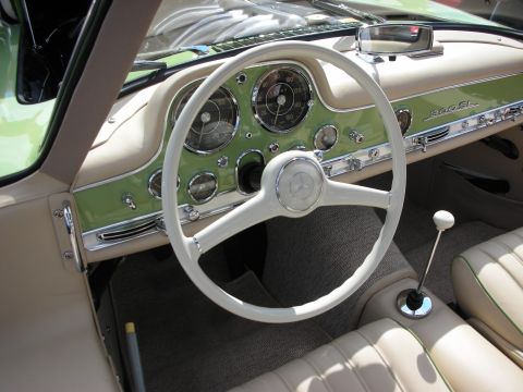 1998 Ford Crown Victoria - cream-and-green interior of a Mercedes 300SL, with a large white steering wheel and 300SL script on the dash.