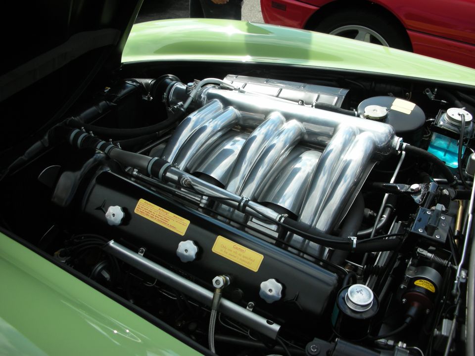 Inline-six engine with polished intake runners in a green car