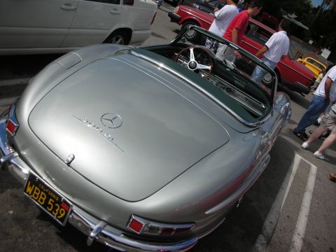 1998 Ford Crown Victoria - silver Mercedes 300SL roadster seen from above and behind with the top down, yellow California plate WBB 539.