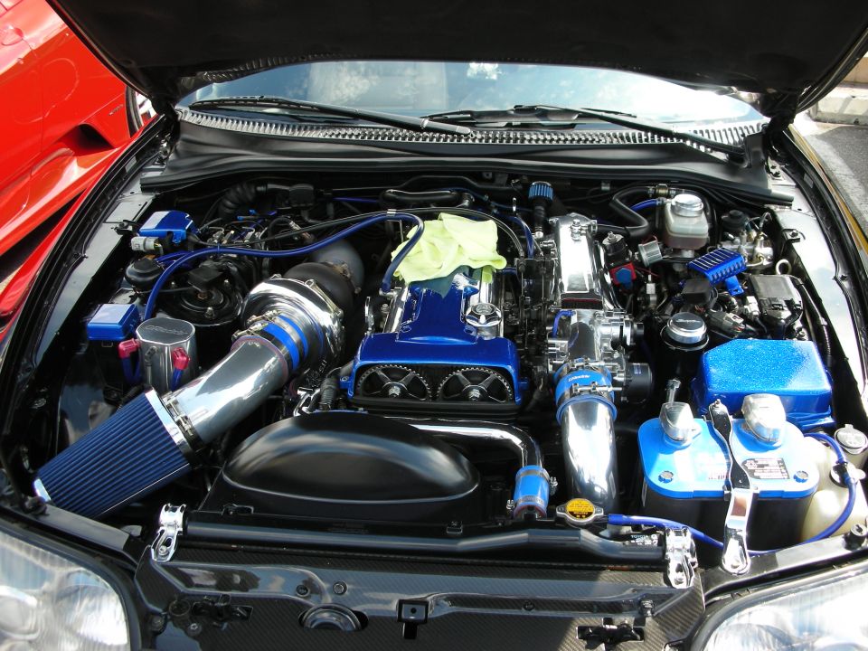 Engine bay with blue turbo piping, chrome intake and blue valve covers