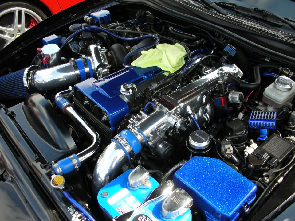 Detailed engine bay with chrome turbo, blue piping and blue valve covers