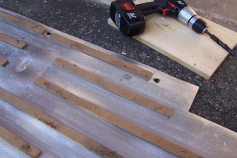 1990 Ford Bronco - Drill and tie-down hardware are laid out on a metal surface, possibly for installation or repair.