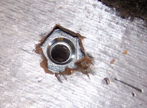 1990 Ford Bronco - A threaded metal insert is visible in a textured surface, possibly for a tie-down point.