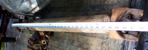 1978 Ford Bronco - A driveshaft is shown with a measuring tape to indicate its length.