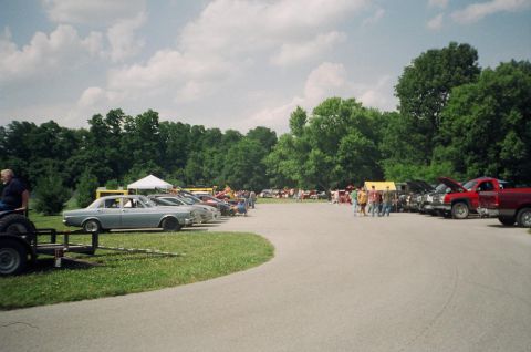 1995 Ford Probe - A car show event with many vehicles and attendees gathered on a sunny day.