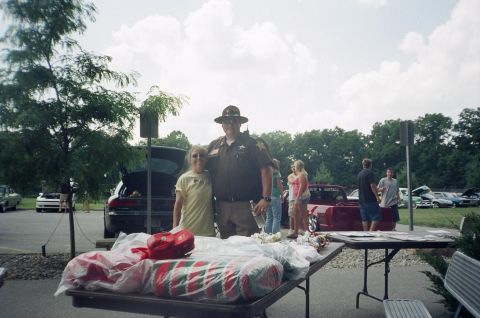 1995 Ford Probe - Outdoor gathering with people and multiple vehicles visible in the background.