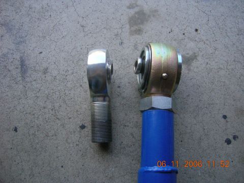 1996 Ford Bronco - A close-up view shows two different types of rod ends, one shiny and one with a gold finish, resting on a textured concrete background.