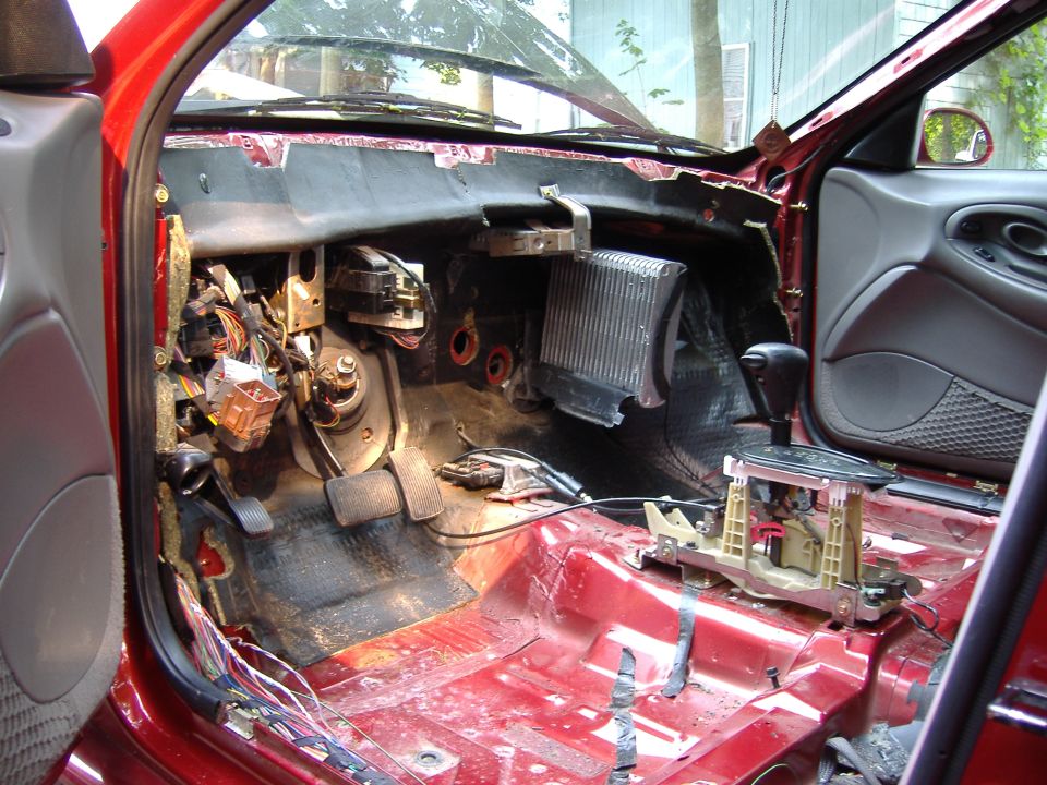 1998 Ford Taurus interior with dashboard removed, showing wiring and pedals