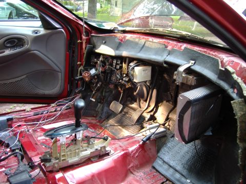 1998 Ford Taurus - Interior view of a 1998 Ford Taurus with the dashboard disassembled, revealing exposed wiring and components.