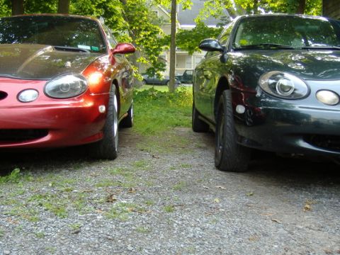1998 Ford Taurus - Two 1998 Ford Taurus sedans are parked next to each other in a driveway.