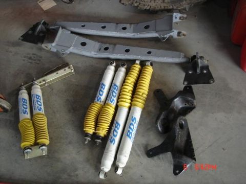 1995 Ford Bronco - Collection of BDS suspension shocks and assorted metal frame components.