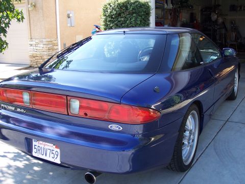 1995 Ford Probe - Rear 3/4 view of a blue 1995 Ford Probe GT parked in a driveway.
