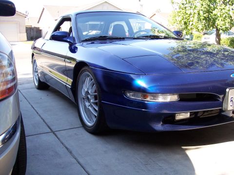 1995 Ford Probe - A blue 1995 Ford Probe is parked in a driveway.