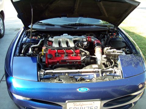 1995 Ford Probe - Engine bay of a 1995 Ford Probe, showing the V6 engine with aftermarket intake components.