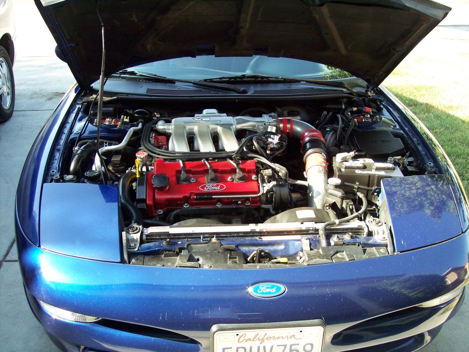 1995 Ford Probe engine bay with red Ford valve covers and silver intake manifold