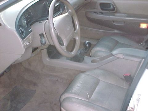 1994 Ford Taurus - The interior of a 1995 Ford Taurus, tan leather seats and a beige dashboard.