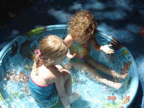 1993 Ford Bronco - Two young girls enjoy a sunny day playing in a small inflatable pool.