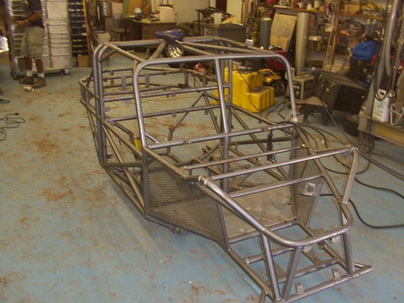 custom tube chassis buggy frame in a workshop, looks like a work in progress