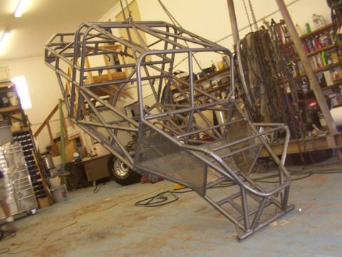 1978 Ford Bronco - A custom-built tube chassis, likely for off-road use, is suspended in a workshop environment.