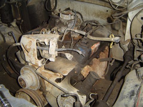 1972 Ford F-100 - Close-up view of a V8 engine, likely from a donor vehicle, showing the carburetor and associated wiring and plumbing.