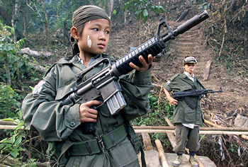 1969 Ford Mustang - A young soldier stands ready with his rifle, accompanied by another soldier in the background, in a jungle setting.