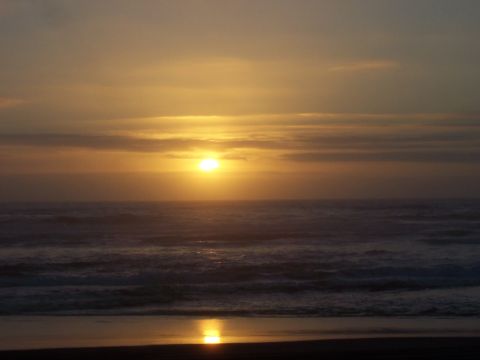 1994 Ford F-150 - Sunset over the ocean with waves and a reflection on the wet sand.