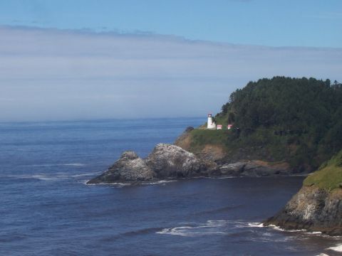 1994 Ford F-150 - Coastal scene with a lighthouse on a cliff overlooking the ocean and rocks.