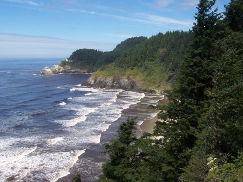 1994 Ford F-150 - A scenic view of the Oregon coast, a lighthouse and the Pacific Ocean under a blue sky.