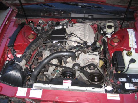 1995 Ford Thunderbird - The engine bay of a 1995 Ford Thunderbird is shown with the hood open.