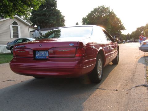 1995 Ford Thunderbird - Rear view of a red Ford Thunderbird coupe parked on a street.