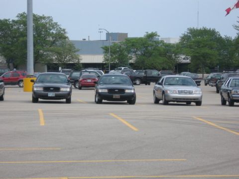 1988 Mercury Grand Marquis - A silver sedan is parked in a lot with other vehicles, showing its front grille.