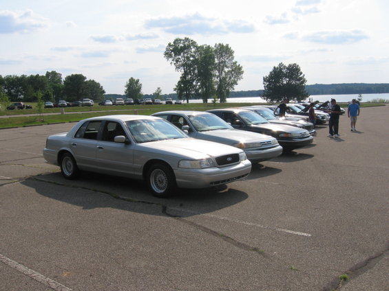 Silver sedan with a prominent grille and headlights, parked in a lot
