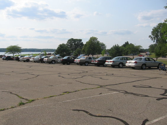 Line of sedans parked in a lot, including a 1988 Mercury Grand Marquis