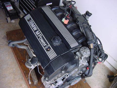 1984 BMW 3 Series - Engine assembly with "BMW M Power" branding is shown, resting on a wooden platform.