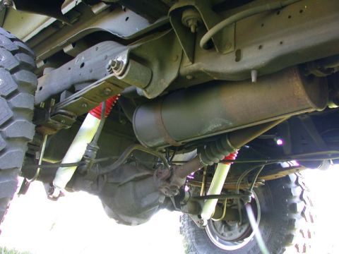 1996 Ford Bronco - The underside of a vehicle is shown, focusing on the suspension and exhaust system components.