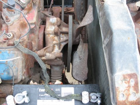 1983 Chevrolet Silverado 1500 - Close-up view of engine components including a fan, radiator, and battery.