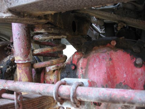 1983 Chevrolet Silverado 1500 - Close-up view of heavily rusted suspension components, likely from an older vehicle.