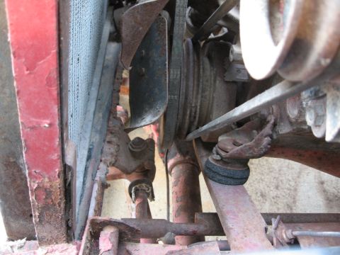 1983 Chevrolet Silverado 1500 - The engine bay shows a fan, belts, and part of the radiator, with visible rust and wear.